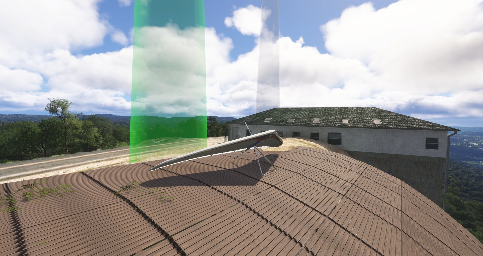 A wooden launch ramp with a parked hang glider and a launch beacon